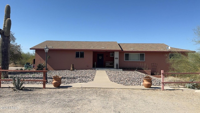 ranch-style home featuring stucco siding