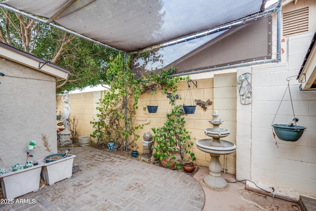 view of patio featuring fence