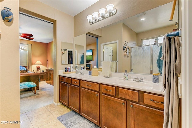 bathroom with tile patterned floors, ceiling fan, vanity, and walk in shower