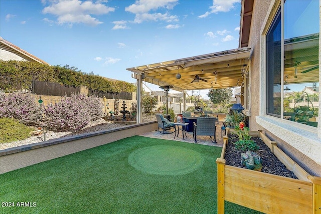 view of yard with a patio and ceiling fan