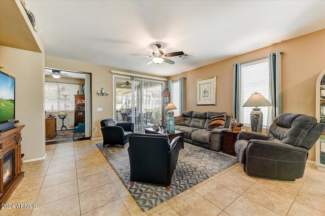 living room featuring ceiling fan and light tile patterned floors