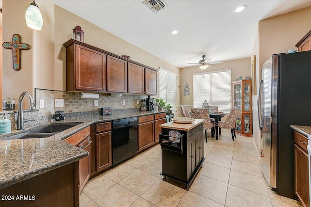 kitchen with ceiling fan, sink, black dishwasher, tasteful backsplash, and stainless steel fridge