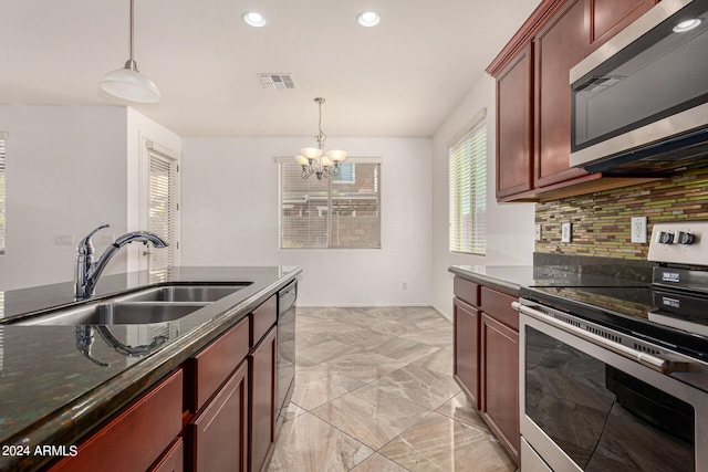 kitchen featuring tasteful backsplash, pendant lighting, stainless steel appliances, an inviting chandelier, and sink