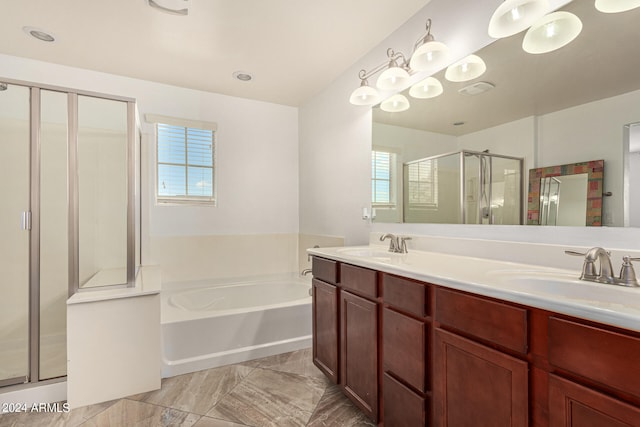 bathroom with shower with separate bathtub, a healthy amount of sunlight, and vanity