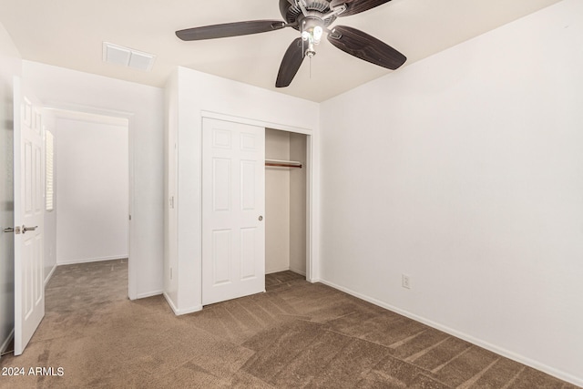 unfurnished bedroom with carpet floors, ceiling fan, and a closet