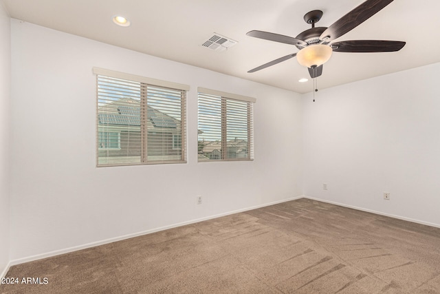 unfurnished room with ceiling fan and carpet floors