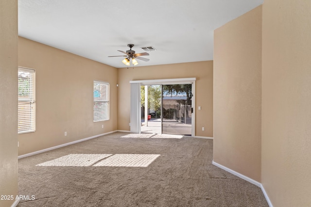 unfurnished room featuring ceiling fan, light carpet, and a healthy amount of sunlight