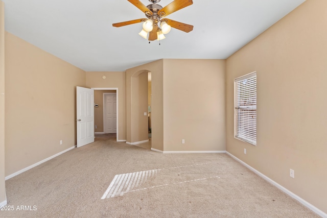 carpeted spare room featuring ceiling fan