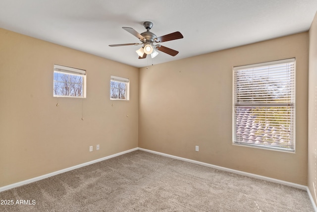 carpeted empty room featuring ceiling fan