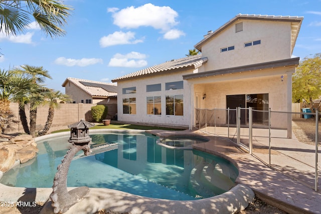 view of swimming pool featuring an in ground hot tub and a patio