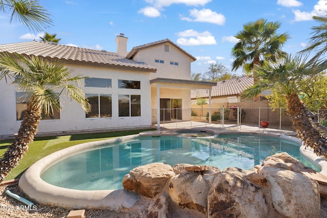 view of pool with an in ground hot tub