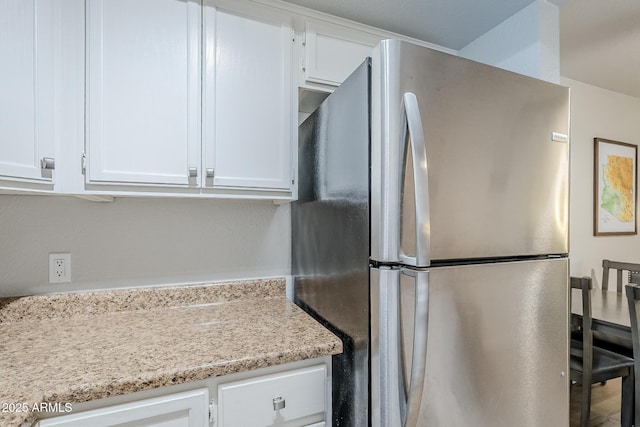 17 E Ruth Ave Unit 303, Phoenix, AZ 85020 - kitchen with freestanding refrigerator and white cabinets