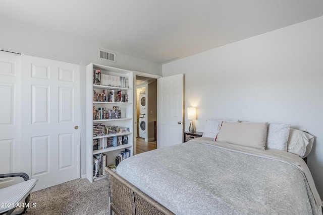 17 E Ruth Ave Unit 303, Phoenix, AZ 85020 - carpeted bedroom featuring estacked washer and dryer