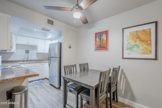 17 E Ruth Ave Unit 303, Phoenix, AZ 85020 - dining space with light wood finished floors, a ceiling fan, and baseboards