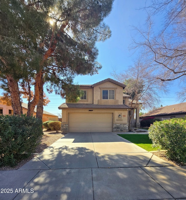 traditional-style home featuring a tile roof, stucco siding, concrete driveway, an attached garage, and stone siding