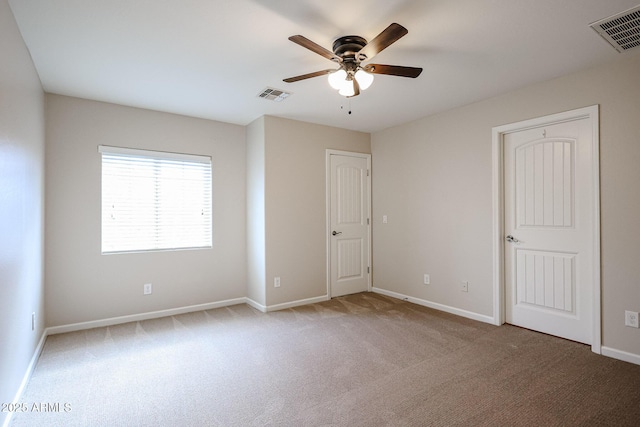 unfurnished bedroom featuring light colored carpet and ceiling fan