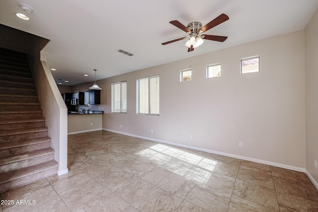 unfurnished living room featuring ceiling fan