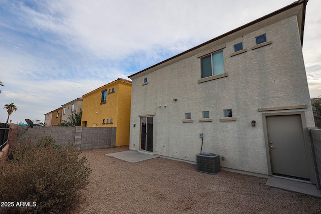 rear view of house with cooling unit