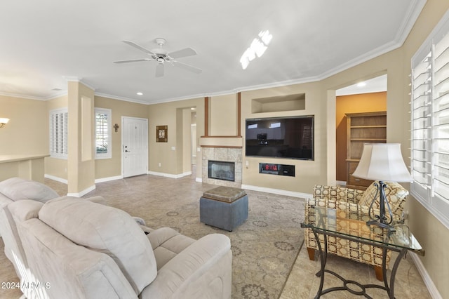 living room with ceiling fan, a fireplace, and ornamental molding