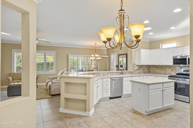 kitchen featuring pendant lighting, white cabinetry, a center island, and stainless steel appliances