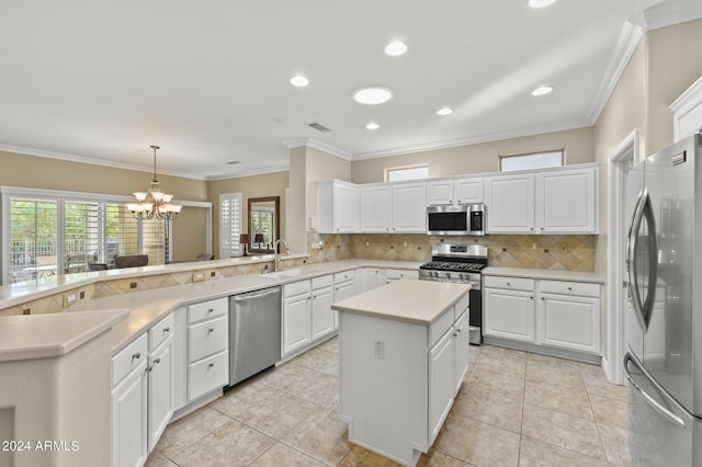 kitchen featuring a kitchen island, stainless steel appliances, and white cabinetry