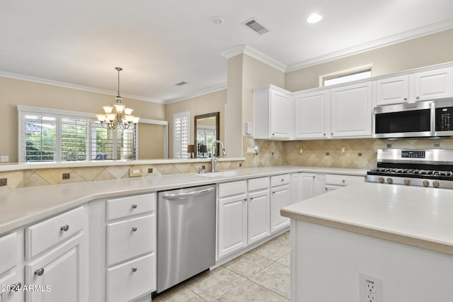 kitchen featuring appliances with stainless steel finishes, crown molding, sink, and white cabinets