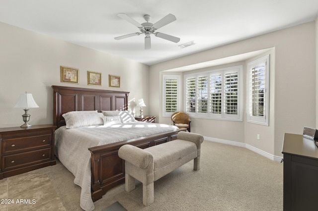 bedroom featuring light carpet and ceiling fan