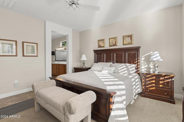 carpeted bedroom featuring ceiling fan and connected bathroom