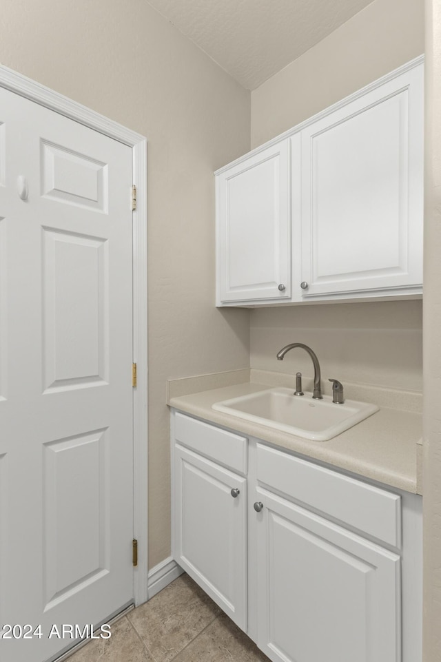 washroom with sink and light tile patterned floors