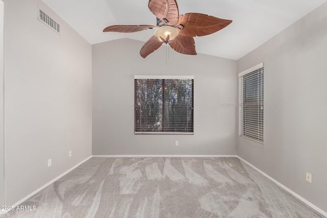 carpeted spare room with vaulted ceiling and ceiling fan