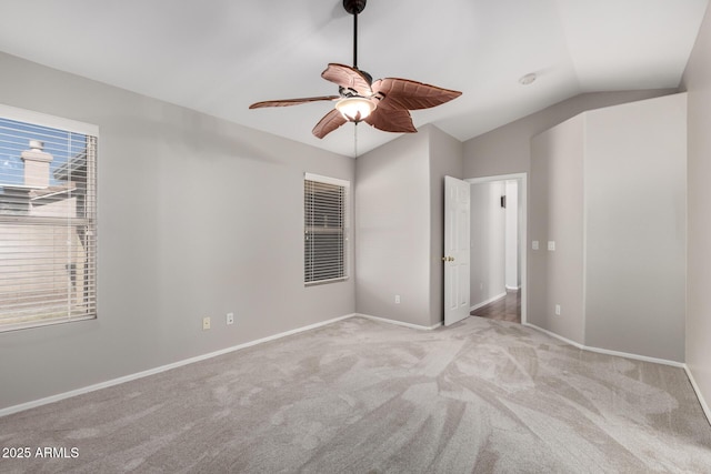 unfurnished bedroom with ceiling fan, light colored carpet, and lofted ceiling