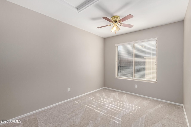 carpeted spare room with ceiling fan