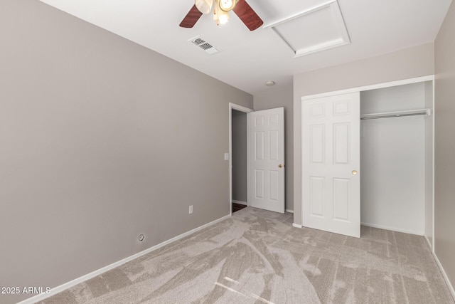 unfurnished bedroom with light carpet, ceiling fan, and a closet