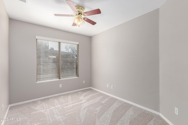 spare room with ceiling fan and light carpet