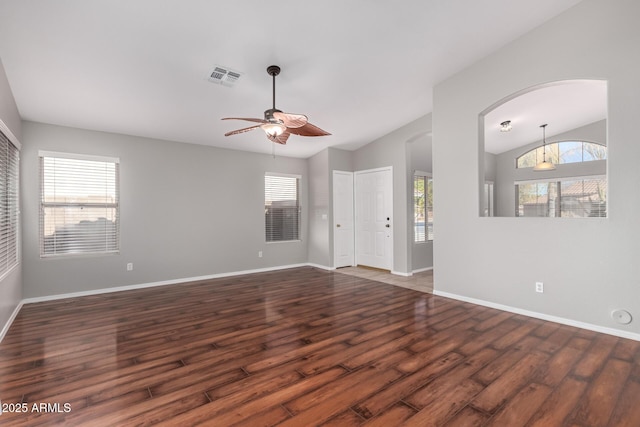 empty room with lofted ceiling, dark wood-type flooring, and ceiling fan