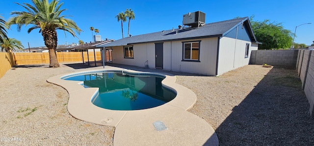 back of house with a fenced in pool, a patio area, and cooling unit