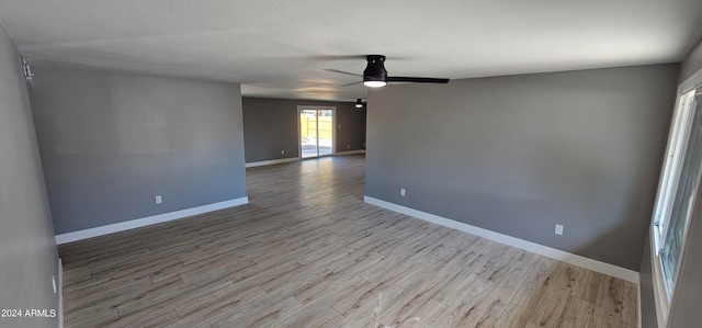 unfurnished room with light wood-type flooring and ceiling fan