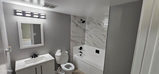 full bathroom with toilet, vanity, and tiled shower / bath