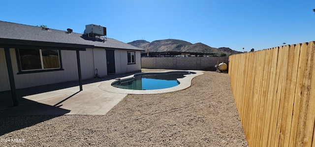 view of swimming pool with a mountain view, central AC unit, and a patio area