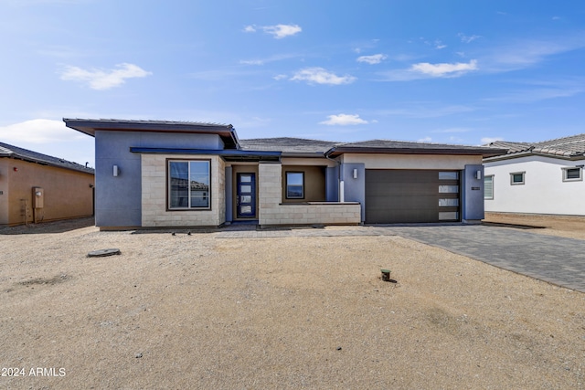 prairie-style house featuring a garage