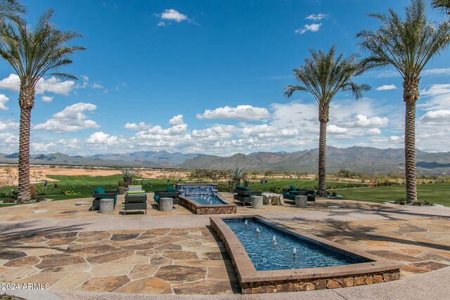 view of pool featuring a mountain view and a patio area