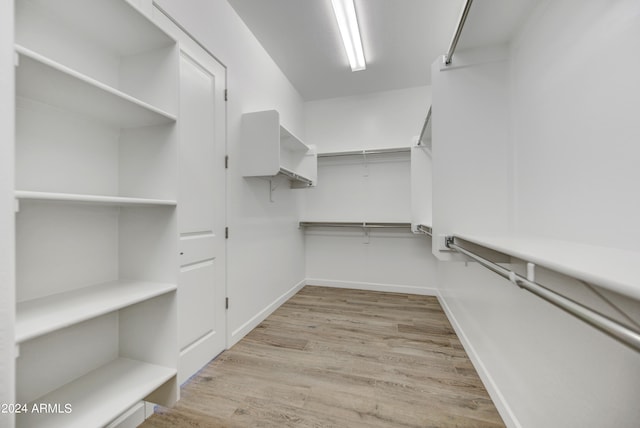 walk in closet featuring light hardwood / wood-style flooring