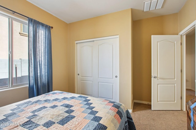 carpeted bedroom featuring a closet