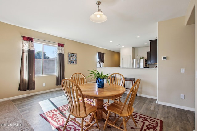 dining area with dark hardwood / wood-style flooring