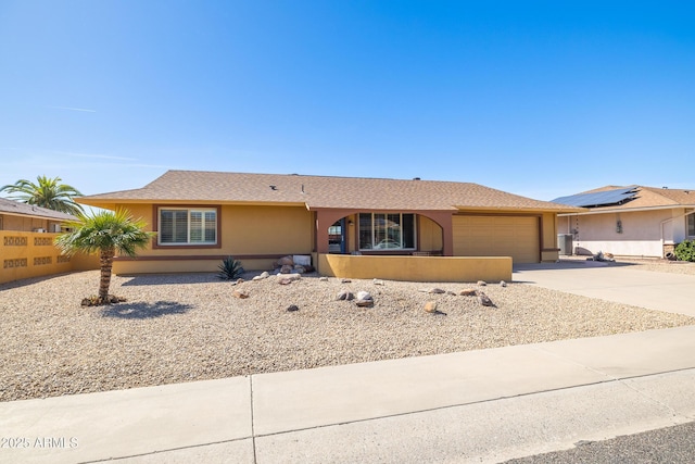 ranch-style home with a garage, driveway, a shingled roof, and stucco siding