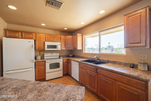 kitchen with light tile patterned floors, recessed lighting, white appliances, a sink, and visible vents