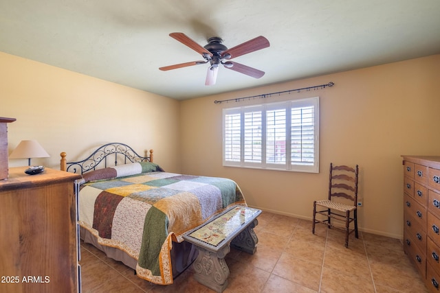 bedroom with light tile patterned flooring, a ceiling fan, and baseboards