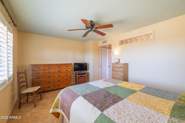 bedroom with ceiling fan, light tile patterned flooring, and visible vents