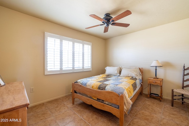 bedroom with a ceiling fan, light tile patterned flooring, and baseboards