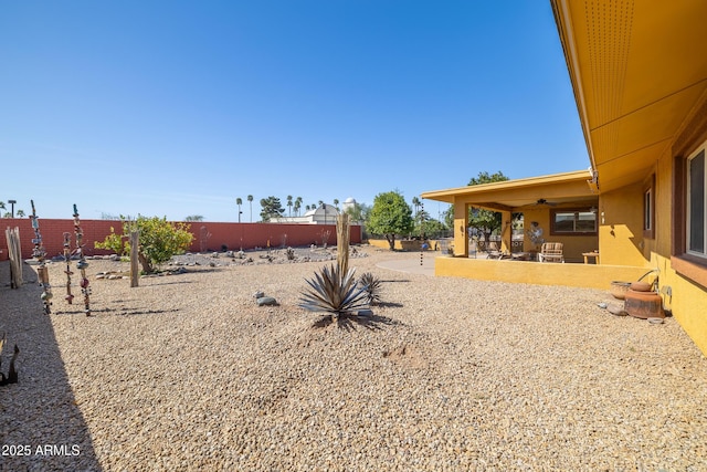 view of yard with a fenced backyard, a patio, and ceiling fan